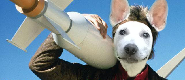 A picture of a serious man holding a rocket, except the man has a goofy dog face.